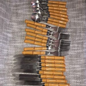 Stainless steel knives forks and spoons. Plastic bamboo handle.